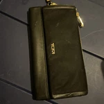 Tumi Voyageur Slg Women's Travel Wallet Black With Gold Hardware Wristlet Dirty Pre-owned. Price: $38.00.